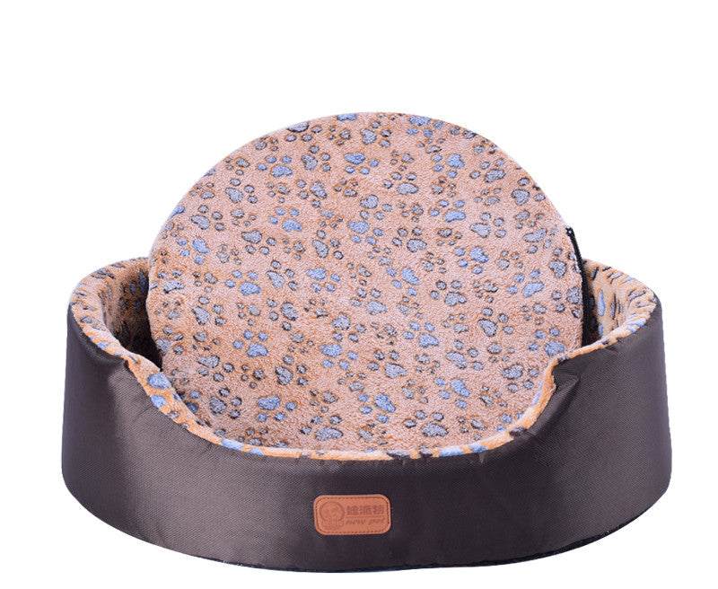 All-Season Dog Bed with a dark brown oval bolster and peach patterned cushion featuring small blue floral motifs