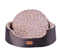 All-Season Dog Bed with a dark brown oval bolster and peach patterned cushion featuring small blue floral motifs