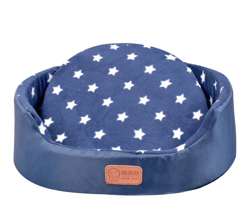 All-Season Dog Bed, oval navy blue fabric pet bed with white stars, raised cushioned sides and a removable-looking center cushion