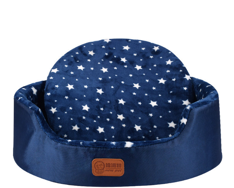 All-Season Dog Bed in navy blue fabric with white star pattern, raised cushioned sides and a rounded backrest