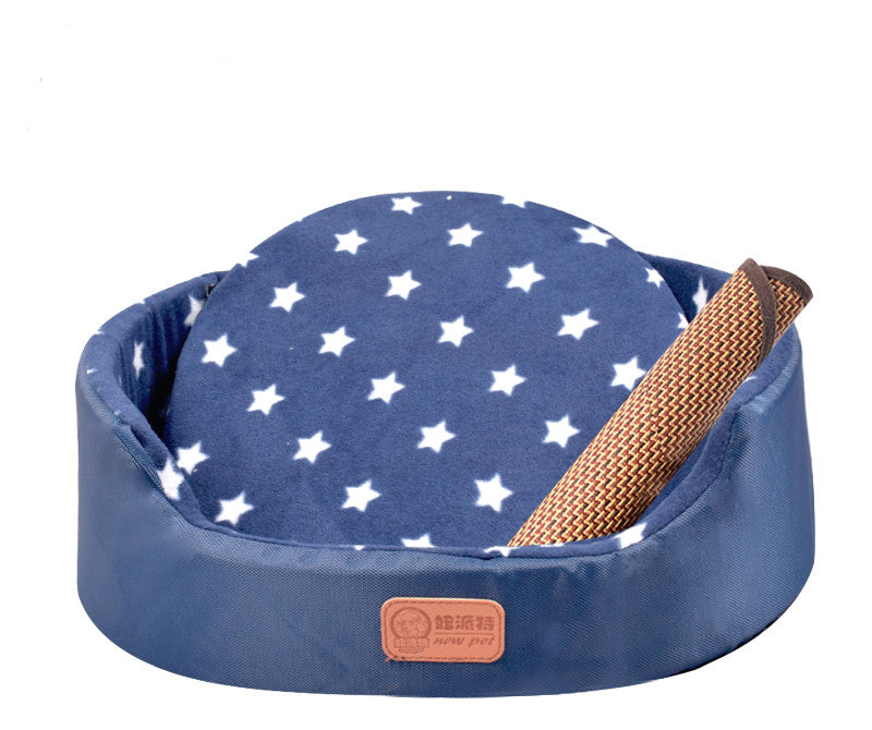All-Season Dog Bed in navy blue fabric with a white star-patterned cushion and raised sides, plus a woven strap detail