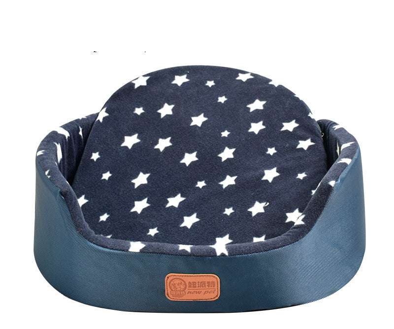 All-Season Dog Bed in navy blue fabric with a white star pattern, featuring raised padded sides and a rounded shape