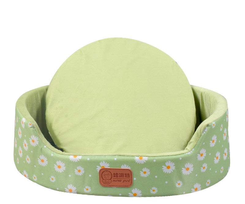 All-Season Dog Bed in pale green fabric with a white daisy print, raised oval sides and a round matching cushion