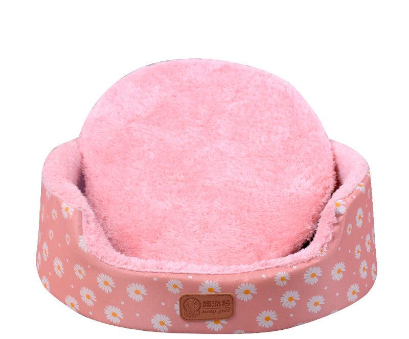 All-Season Dog Bed in pink with a soft plush cushion, raised oval sides and a white daisy print