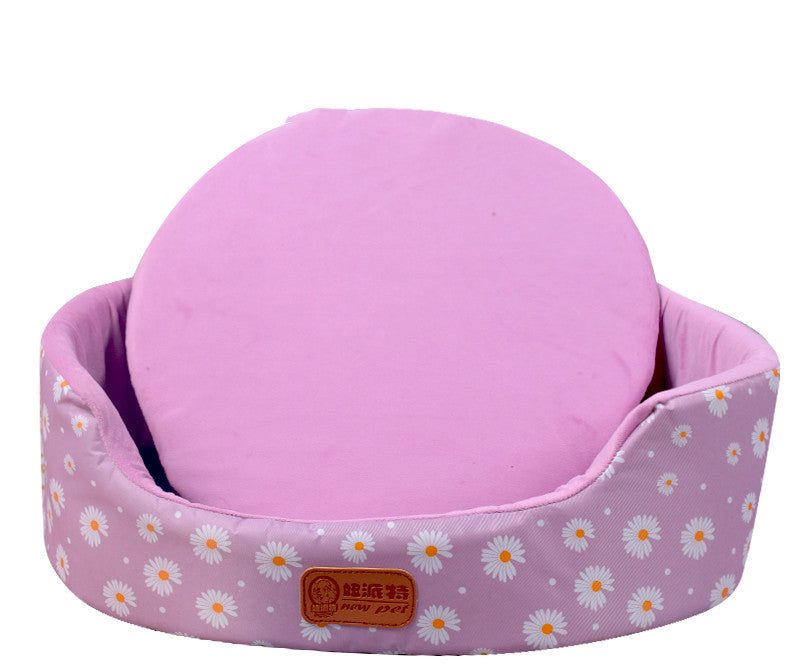 All-Season Dog Bed with pink fabric, daisy-print oval bolster sides and a removable round cushion