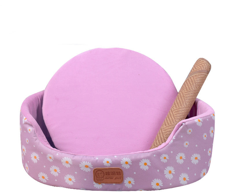 All-Season Dog Bed in pink floral fabric with raised oval sides, a round cushion, and a textured chew toy