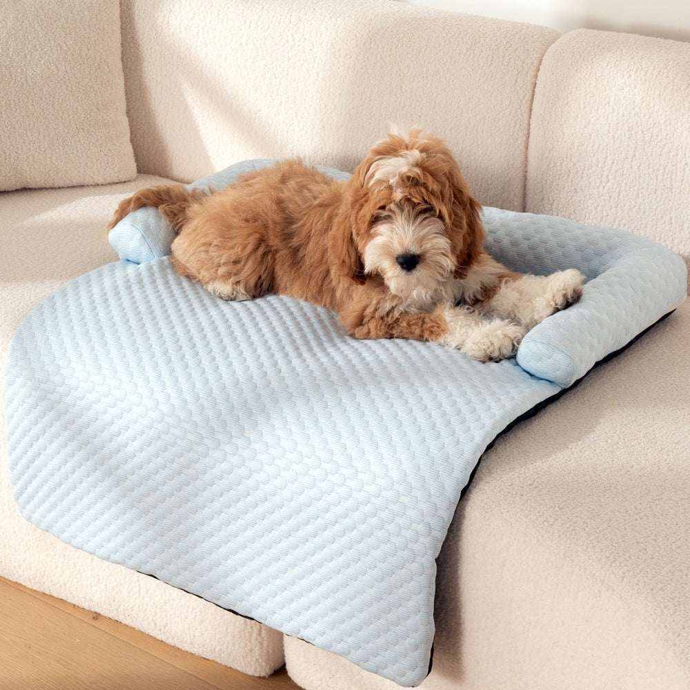 Bed Pet Cooling Mat in pale blue quilted fabric with a padded raised edge, shown beneath a resting brown dog