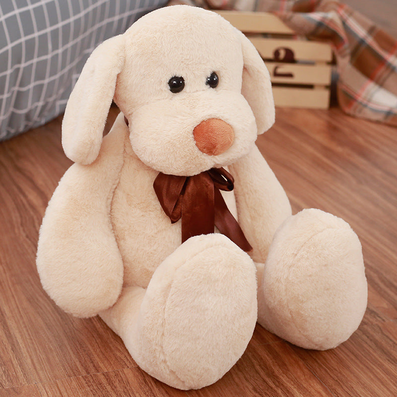 Cute Dull Dog Doll in soft cream short plush, with floppy ears, a round brown nose, and a dark brown bow