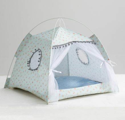 Enclosed Pet Bed in pale mint patterned fabric with an arched tent shape, open white curtains and a blue cushioned base