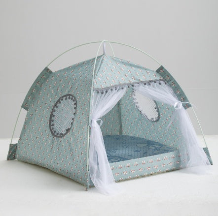 Enclosed Pet Bed in pale teal patterned fabric, tent-shaped with a domed frame, mesh windows and sheer front curtains