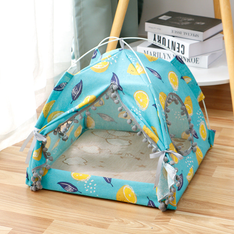 Enclosed Pet Bed in turquoise fabric with yellow lemon and blue leaf print, featuring a tent-like canopy and open entrance