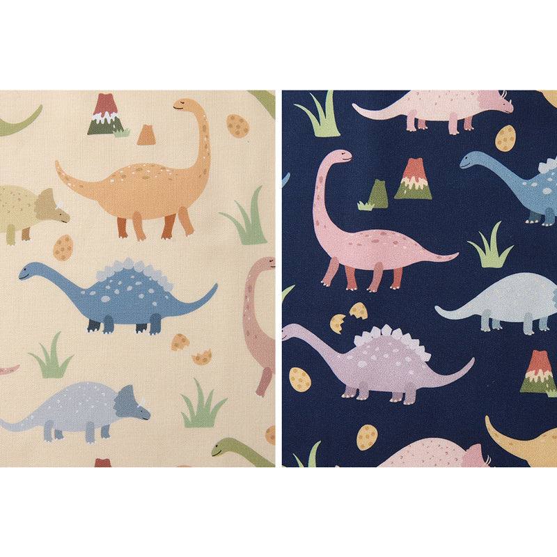 Handmade Printed Fabric in cream and navy cotton, patterned with colorful cartoon dinosaurs, plants and fossils