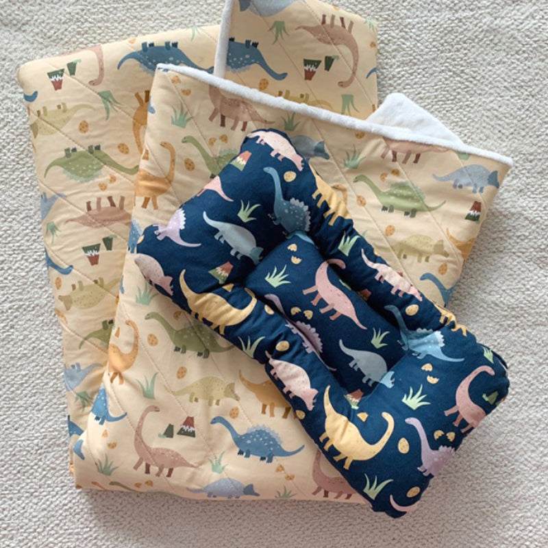 Handmade Printed Fabric in cream and navy cotton, covered with colorful cartoon dinosaurs and small plant motifs.