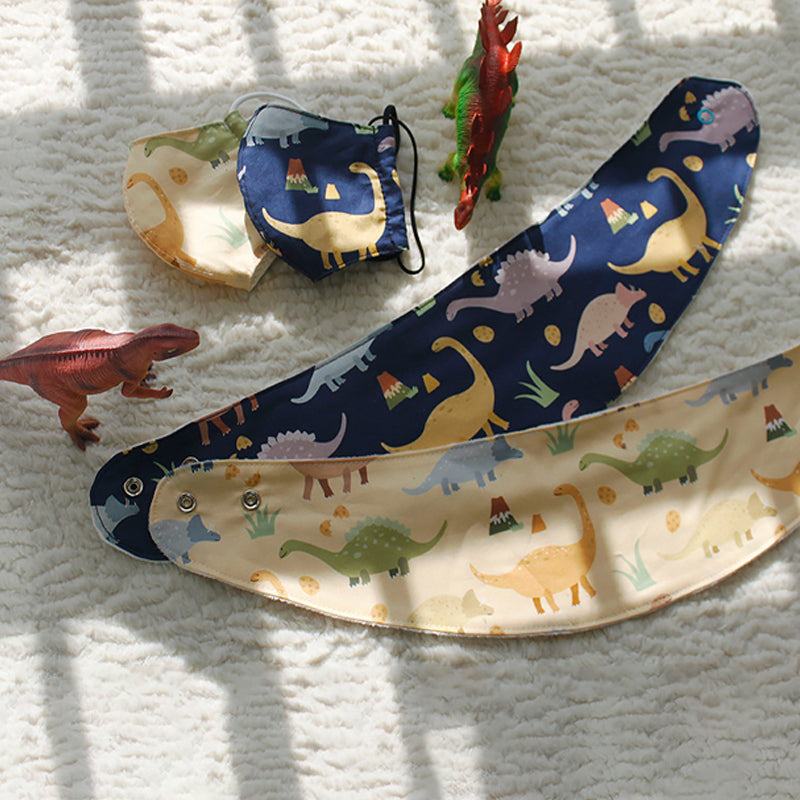 Handmade Printed Fabric in navy blue and cream cotton, patterned with colorful cartoon dinosaurs and playful details.
