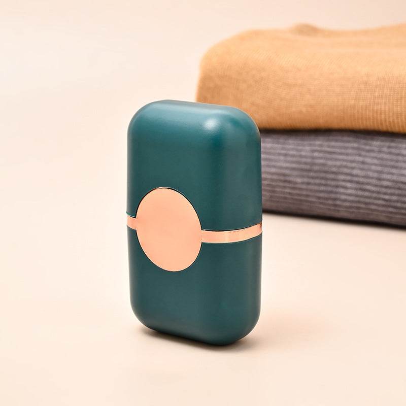 Pet Hair Double Headed lint roller in dark green ABS plastic with rose-gold accents and a compact rounded case