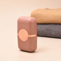Pet Hair Double Headed lint roller in dusty pink ABS plastic, with a rounded rectangular case and circular detail