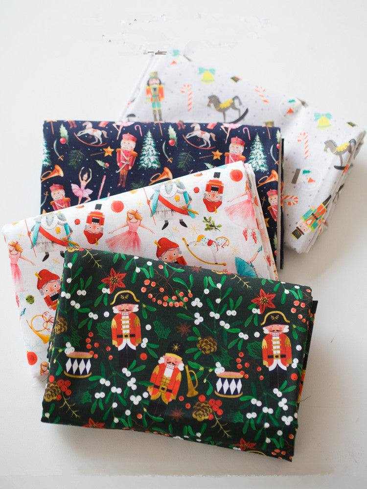 Printed Nutcracker Fabric in cotton with festive character prints, showing toy soldiers, drums, trees and holiday motifs