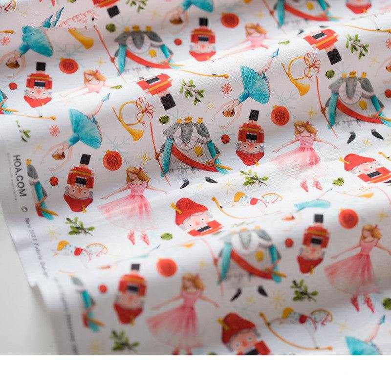 Printed Nutcracker Fabric in white cotton with colorful repeating nutcracker, ballerina, and festive character print