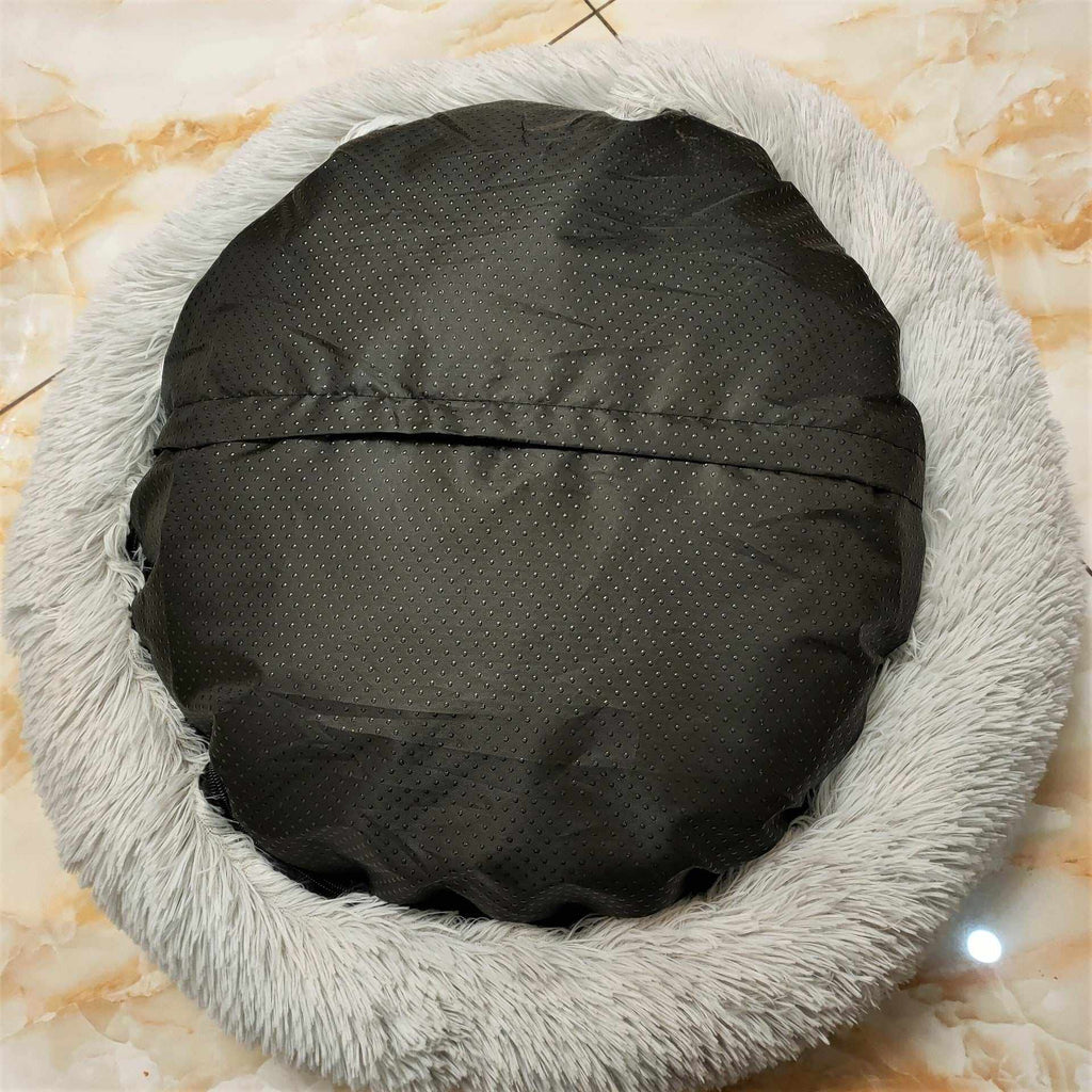 Removable And Washable Dog Bed with a black dotted fabric base and thick light gray plush fur rim