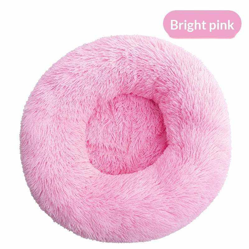 Removable And Washable Dog Bed in bright pink plush, with a round donut shape and raised cushioned rim