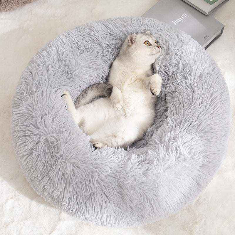 Removable And Washable Dog Bed in light gray plush with a shaggy round bolster design, cradling a reclining cat