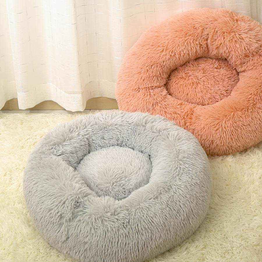 Removable And Washable Dog Bed in plush gray with a round raised rim and peach bed behind it